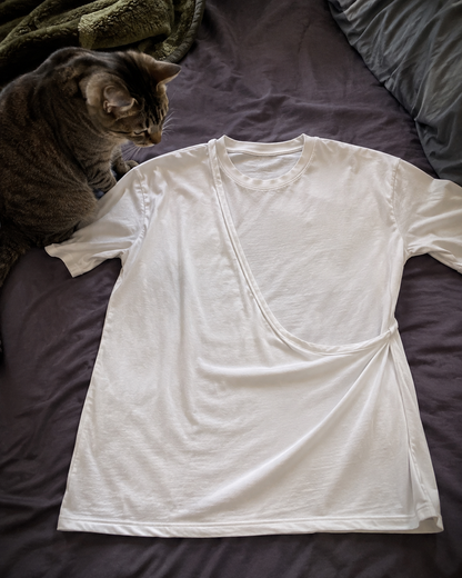 PawPal t-shirt laid flat beside a cat showing pouch construction